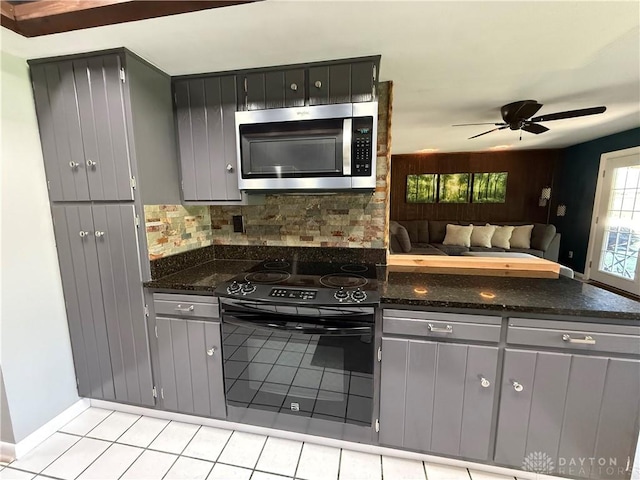 4220 Sillman Pl, Kettering, OH 45440 - kitchen featuring gray cabinetry, stainless steel microwave, black electric range, open floor plan, and backsplash