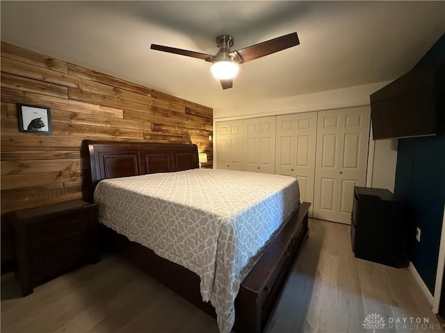 4220 Sillman Pl, Kettering, OH 45440 - bedroom featuring wood finished floors, wooden walls, a closet, and ceiling fan