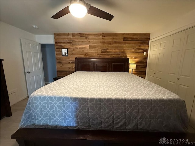 4220 Sillman Pl, Kettering, OH 45440 - bedroom featuring a closet, wood walls, and ceiling fan