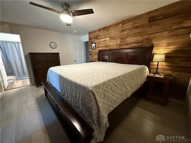 4220 Sillman Pl, Kettering, OH 45440 - bedroom featuring wooden walls, light wood-type flooring, and a ceiling fan