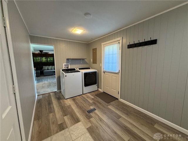 4220 Sillman Pl, Kettering, OH 45440 - laundry area with washing machine and dryer, ornamental molding, dark wood-type flooring, healthy amount of natural light, and wooden walls