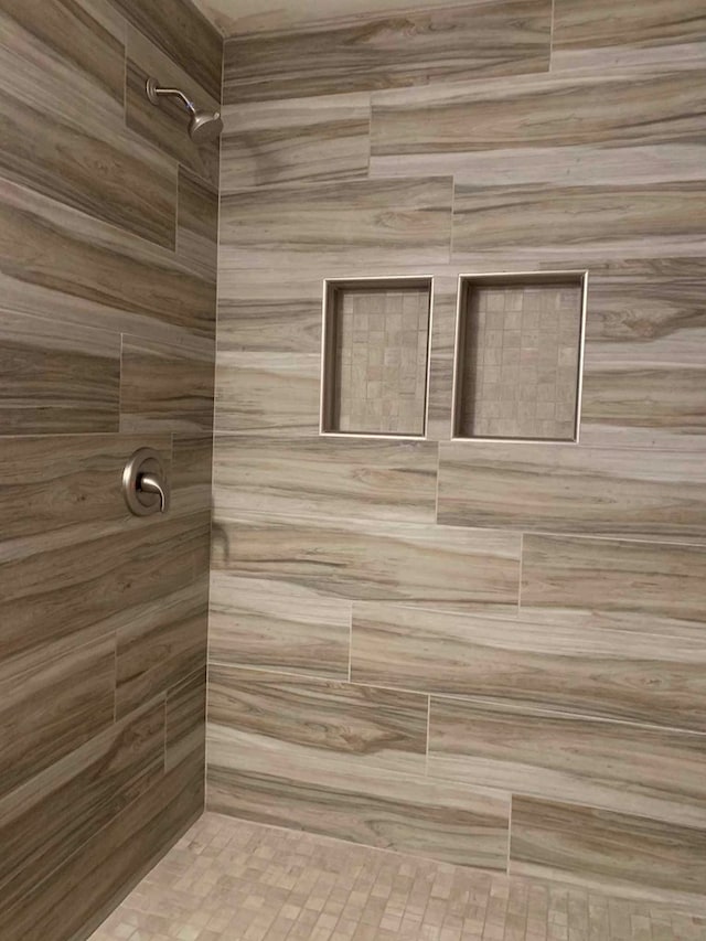 bathroom with a tile shower