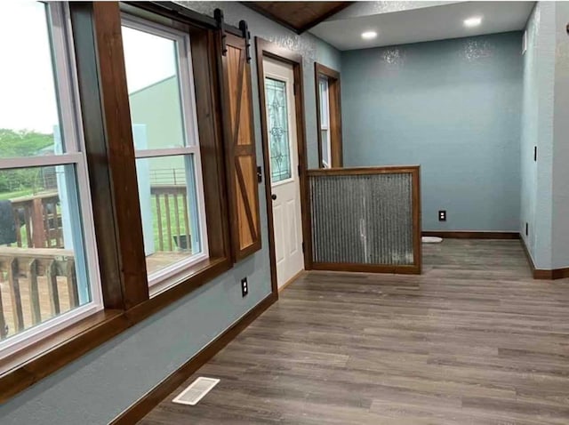 doorway featuring hardwood / wood-style floors and a barn door