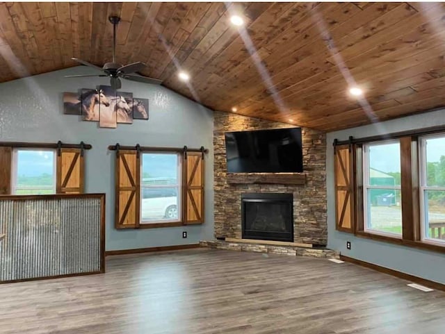 unfurnished living room featuring hardwood / wood-style floors, a wealth of natural light, ceiling fan, and wooden ceiling