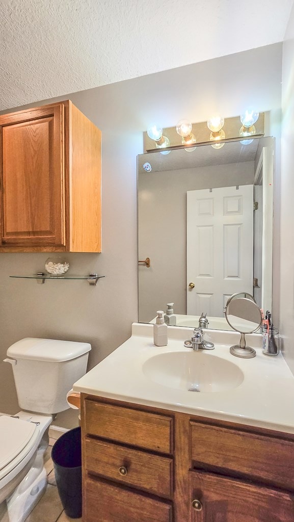 26484 State Highway 3, Kirksville, MO 63501 - half bath with vanity, a textured ceiling, and tile patterned floors