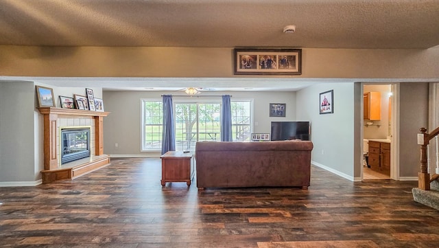 26484 State Highway 3, Kirksville, MO 63501 - living area featuring dark wood-style flooring, a tiled fireplace, and stairway