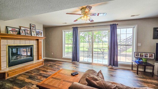 26484 State Highway 3, Kirksville, MO 63501 - living area with hardwood / wood-style flooring, ceiling fan, a tile fireplace, and a textured ceiling