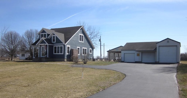 view of front of property featuring an outbuilding and a front lawn