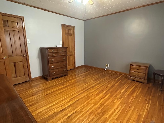 bedroom with light wood-type flooring and ornamental molding