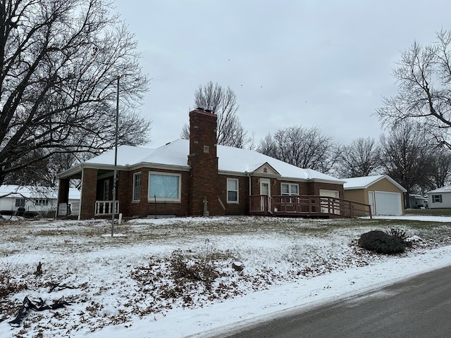 view of front facade featuring a garage and an outdoor structure