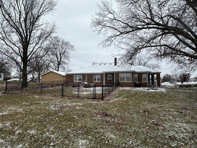 rear view of property featuring a yard