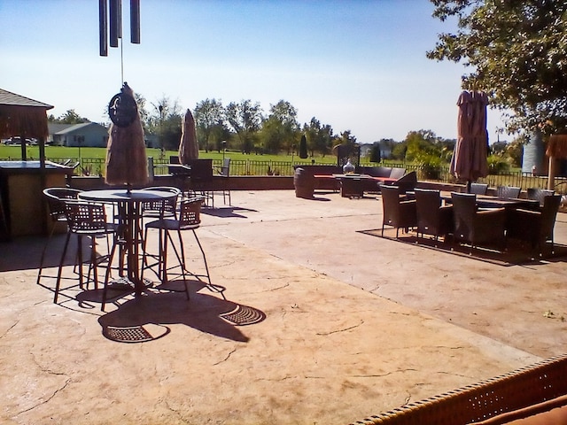 view of patio featuring outdoor dining area and fence