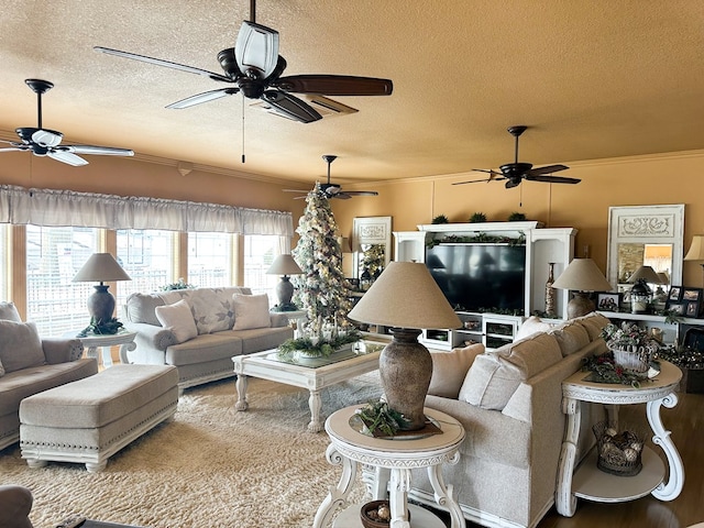 living room with ornamental molding, wood finished floors, a textured ceiling, and a ceiling fan