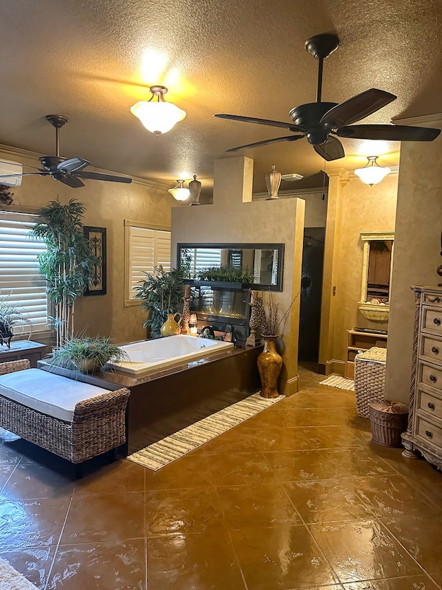 interior space featuring ceiling fan and a textured ceiling