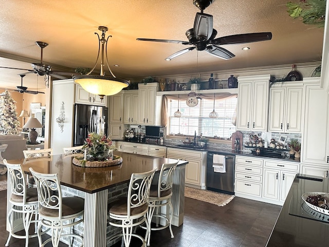 kitchen featuring stainless steel appliances, dark countertops, and a kitchen bar