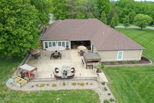 back of house featuring outdoor dining area, a gazebo, a patio, and a yard