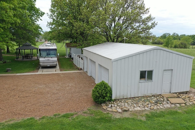 view of outdoor structure featuring a gazebo and an outbuilding