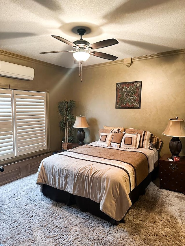 bedroom with ceiling fan, ornamental molding, a wall mounted air conditioner, a textured ceiling, and carpet floors