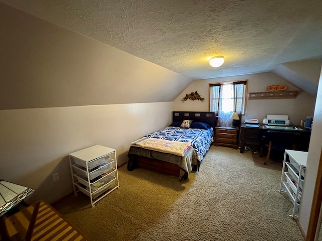 bedroom with lofted ceiling, a textured ceiling, and carpet flooring