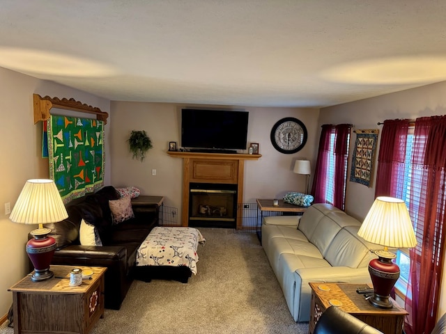 carpeted living room with a glass covered fireplace