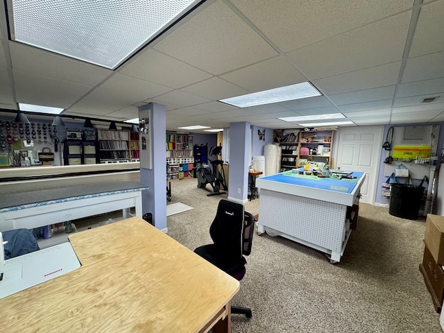 office space with a drop ceiling and carpet flooring