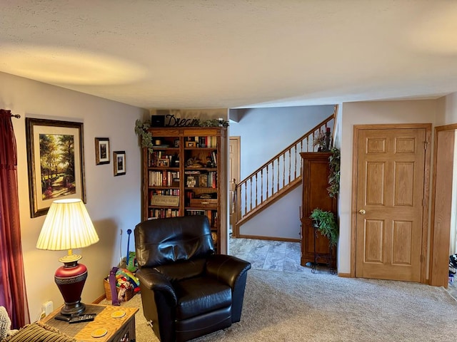 sitting room with stairway and carpet