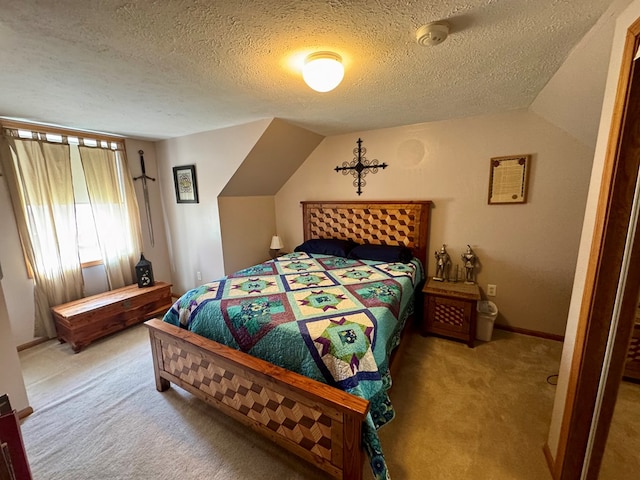 bedroom featuring light carpet, a textured ceiling, baseboards, and vaulted ceiling