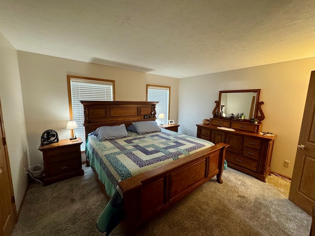 bedroom featuring light colored carpet and a textured ceiling