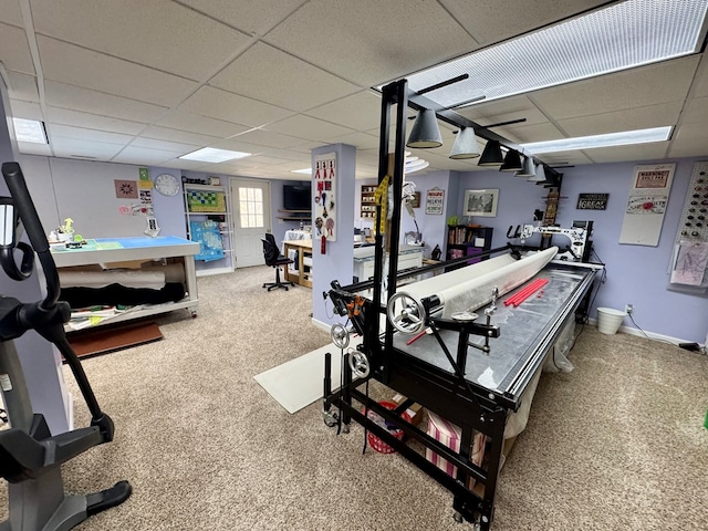 recreation room with a drop ceiling, baseboards, and carpet flooring