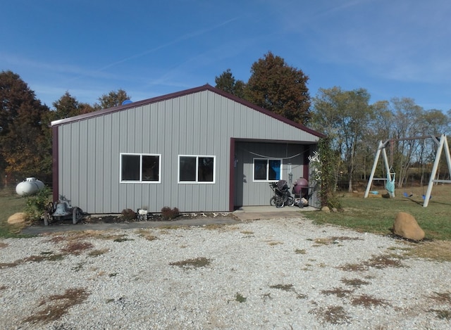 view of property exterior with a playground