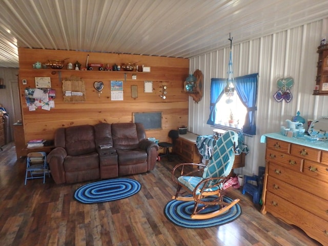 living room featuring dark hardwood / wood-style flooring and wood walls