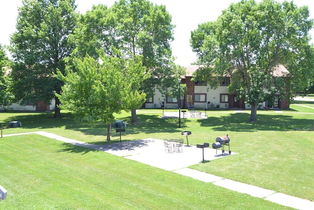 view of property's community with a lawn