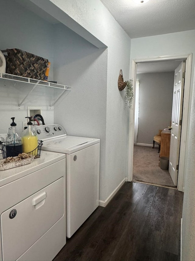 laundry area featuring baseboards, separate washer and dryer, laundry area, a textured ceiling, and dark wood-style floors