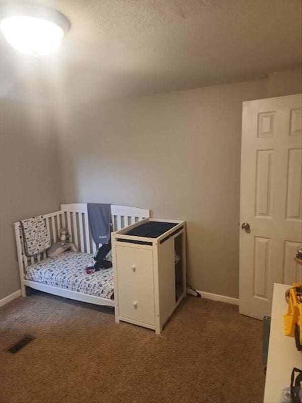 unfurnished bedroom featuring dark carpet