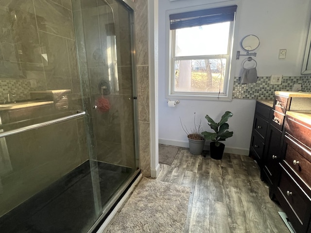 113 N Cottage Grove Ave, Kirksville, MO 63501 - full bathroom with tasteful backsplash, a shower stall, baseboards, wood finished floors, and vanity