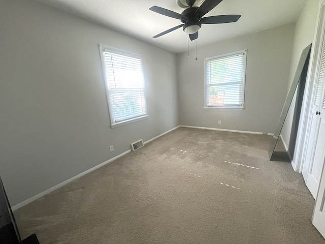 1713 Fairchild St, Chillicothe, MO 64601 - unfurnished bedroom featuring multiple windows, carpet floors, and ceiling fan