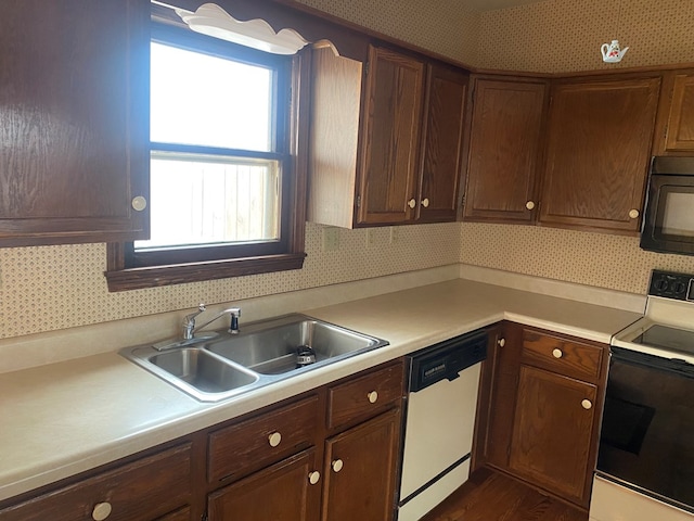 911 Cherry St, Chillicothe, MO 64601 - kitchen featuring light countertops, a sink, black microwave, electric range oven, and white dishwasher
