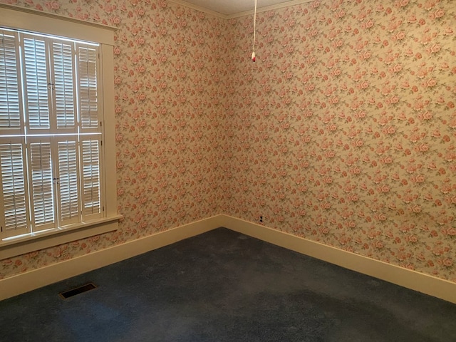 911 Cherry St, Chillicothe, MO 64601 - carpeted spare room featuring baseboards, visible vents, ornamental molding, and wallpapered walls