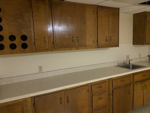 911 Cherry St, Chillicothe, MO 64601 - kitchen featuring light countertops, a sink, and brown cabinetry