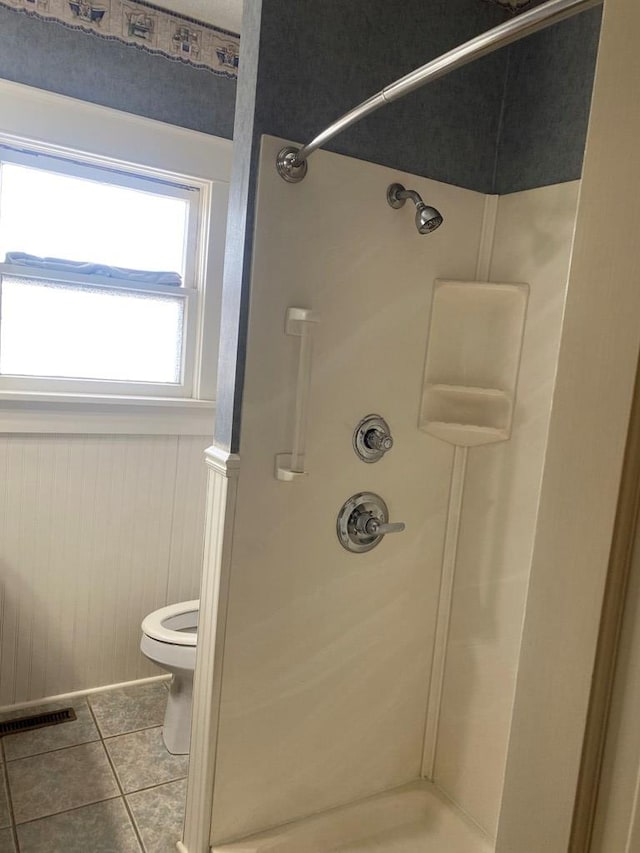 911 Cherry St, Chillicothe, MO 64601 - bathroom featuring a shower stall, tile patterned floors, visible vents, and toilet