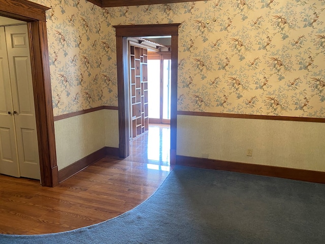 911 Cherry St, Chillicothe, MO 64601 - empty room with a wainscoted wall and wallpapered walls