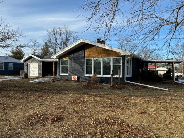 view of side of home with a carport