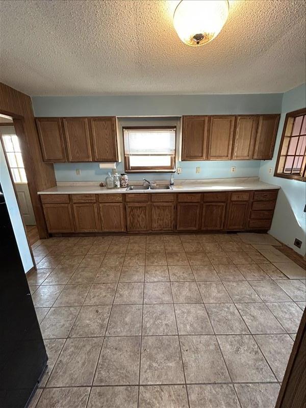 803 Coates St, Macon, MO 63552 - kitchen featuring a wealth of natural light, brown cabinetry, and light countertops