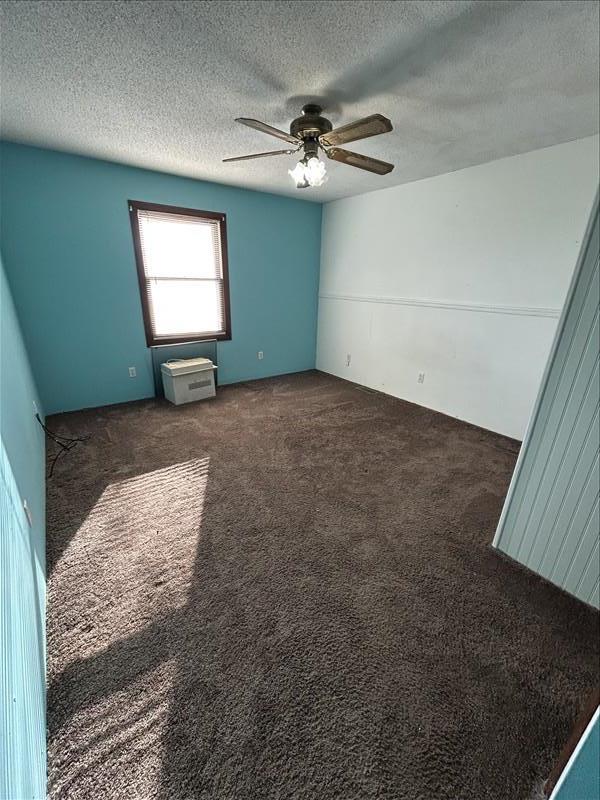 803 Coates St, Macon, MO 63552 - unfurnished room with a ceiling fan, dark colored carpet, and a textured ceiling
