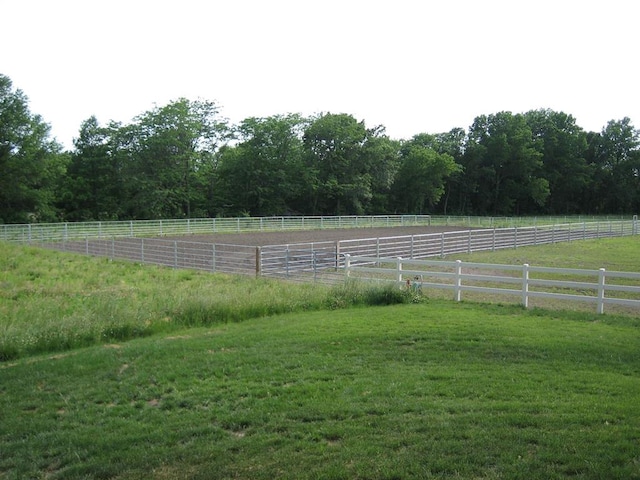 view of yard with a rural view and fence