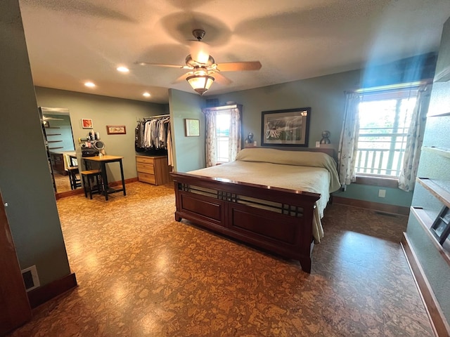 bedroom with visible vents, baseboards, and multiple windows