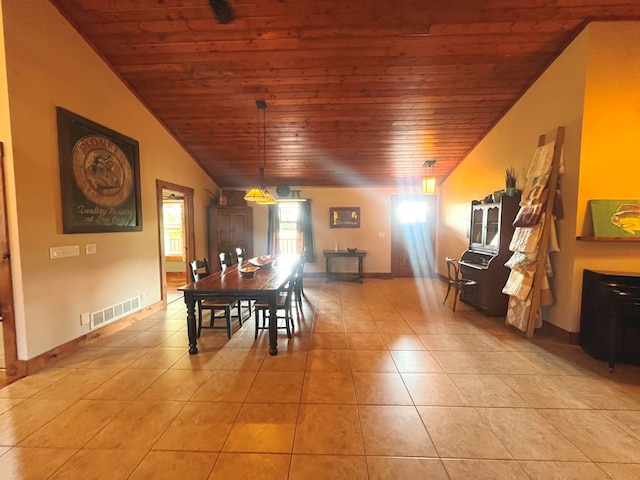 dining space featuring wood ceiling, light tile patterned floors, visible vents, and baseboards