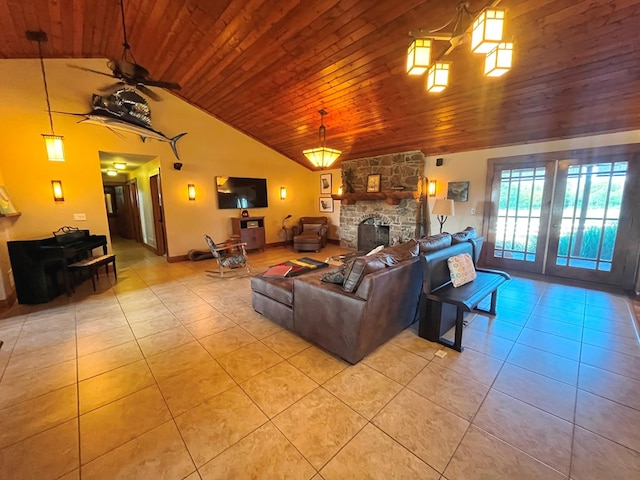 living room featuring a ceiling fan, wood ceiling, a fireplace, and light tile patterned floors