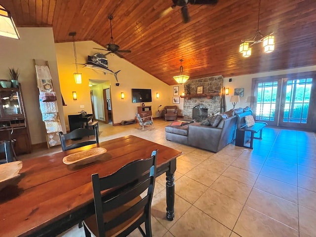 dining space featuring light tile patterned floors, wooden ceiling, ceiling fan, vaulted ceiling, and a fireplace