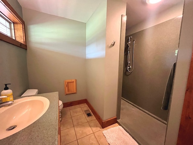 bathroom with visible vents, toilet, vanity, walk in shower, and tile patterned floors